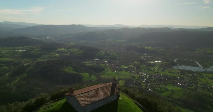 Sobrevolando la ermita con Gernika de fondo al atardecer