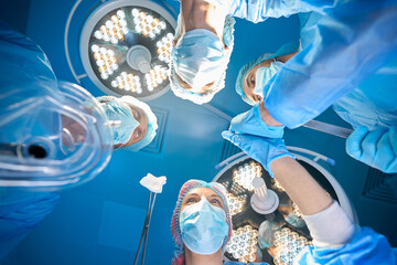 Surgeon and assistants i operating room performing operation