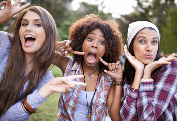 Funny face, portrait and friends in a park with silly, fun or bonding on vacation, weekend or reunion in nature. Crazy, expression and gen z women in a forest with goofy, comic or joke and gesture - obrazy, fototapety, plakaty