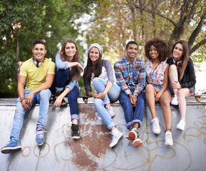 Happy, portrait and group of friends at skatepark for bonding, skating and sitting together. Smile,...