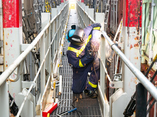 Seaman crew member fitter welder of cargo vessel is repairing ship structure lashing bridge by...
