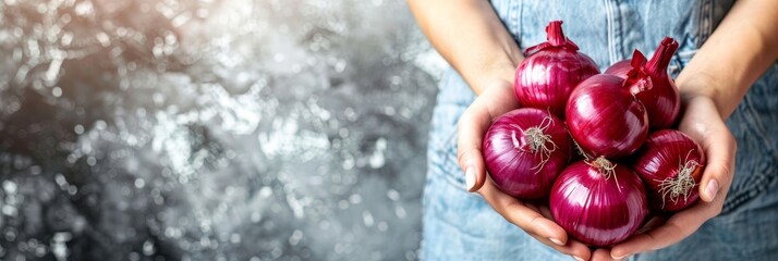 Hand holding red onion with blurred onion selection background for text placement - obrazy, fototapety, plakaty