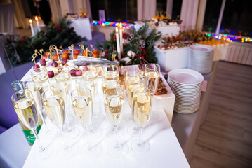 Serving the festive table at a wedding event. Decorating the wedding table with bouquets of flowers. Cutlery at a party