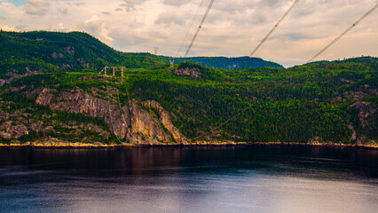 Anse de Tabatière, Canada - August 16 2019: Electricity tower and Saguenay river from the Anse de...