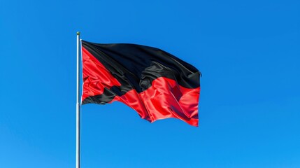 A Vibrant Depiction of a National Flag Fluttering Against a Clear Blue Sky