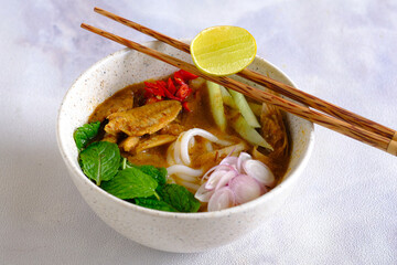 laksa ikan, asam laksa, rice noodle,vegetables, filet fish with sour soup, popular in penang, malaysia