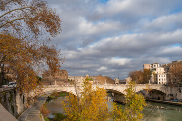 Fototapeta na wymiar daytime winter cityscape of a bridge and tiber river in rome