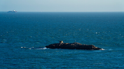 Fototapeta premium An isolated island in the blue sea