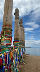 prayer pillars with ribbons on the high shore of the deepest lake in the world