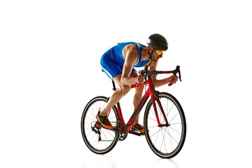 Obraz premium Concentrated and motivated man in sportswear and helmet, bicyclist in motion, training isolated on white studio background. Concept of sport, active and healthy lifestyle, speed, endurance, hobby