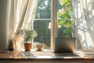 A laptop is on a table next to a potted plant and a cup. The scene is bright and sunny, with the sunlight streaming in through the window