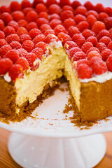 Food, dessert and cheesecake for bakery, raspberries and sweet snack for eating. Fruit, cream and cake stand for display on table in pastry restaurant, creamy and luxury baked confection with berries
