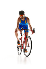 Obraz na płótnie Canvas Front view image of man, athlete in blue sportswear helmet and goggles in motion training on bike isolated on white studio background. Concept of sport, active and healthy lifestyle, speed, endurance