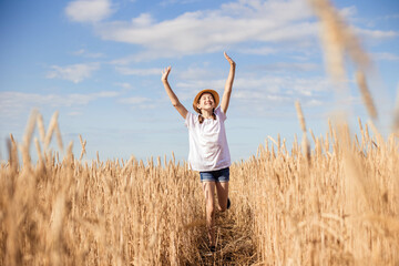 Naklejka na ściany i meble Girl teenager in field on blue sky background, copy space