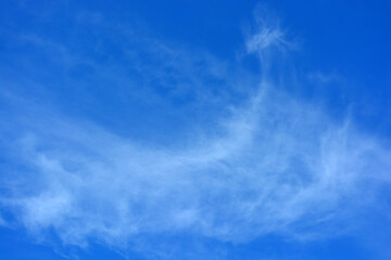 Beautiful and unusual nature, bright light blue sky with small white clouds.