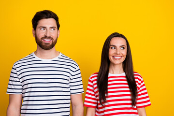 Photo portrait of lovely young couple look empty space promo wear trendy striped garment isolated on yellow color background