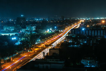 vehicle light trails, illuminated night cityscape. long exposure shot, hight angle view,
