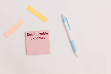 Office scene with sticky note; with text "Reimbursable Expenses" neatly placed on a desk