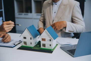 Real estate agent talked about the terms of the home purchase agreement and asked the customer to sign the documents to make the contract legally, Home sales and home insurance concept.