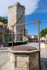 Fototapeta na wymiar Square of the five wells Trg pet bunara, Captain's tower Kapetanova kula, Church tower of San Simeon Crkva sv. Simoom, in the old historic center of the city Zadar Croatia.