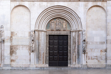 Fototapeta na wymiar Main facade of Zadar Cathedral Prvostolnica SV. Stošija (Anastazija) the largest in the Dalmatia region of Croatia. It was built between the 12th and 14th centuries, Romanesque and Gothic style.