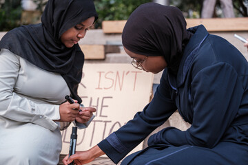 Two young Arab activists holding banners for a peace demonstration. Concept: stop war