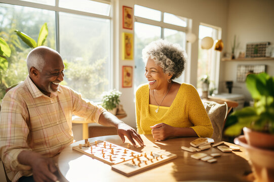 Beautiful loving couple in a retirement home. Senior man and a senior lady playing table game in a nursing home. Housing facility intended for the elderly people.