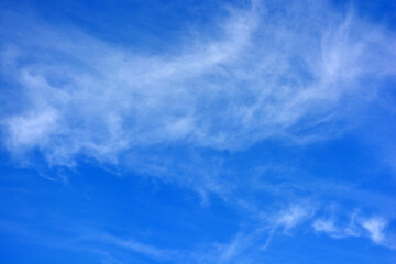 Beautiful and unusual nature, bright light blue sky with small white clouds.