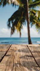 Fototapeta premium Empty wooden planks table against a blurred background with a sea coast with palm trees during the day