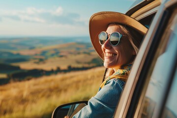A woman traveler smiling as they hit the road for a vacation by car, passing through a scenic countryside landscape with rolling hills and green fields - obrazy, fototapety, plakaty