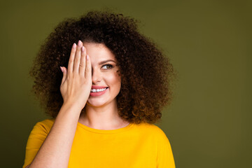 Portrait of girl chevelure hairstyle beaming smile girl hand cover eye look placard check vision isolated on khaki color background