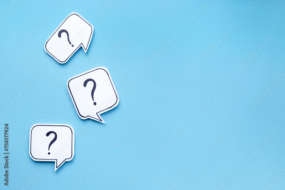 Wall mural question marks on paper speech bubbles. faq concept or search information concept