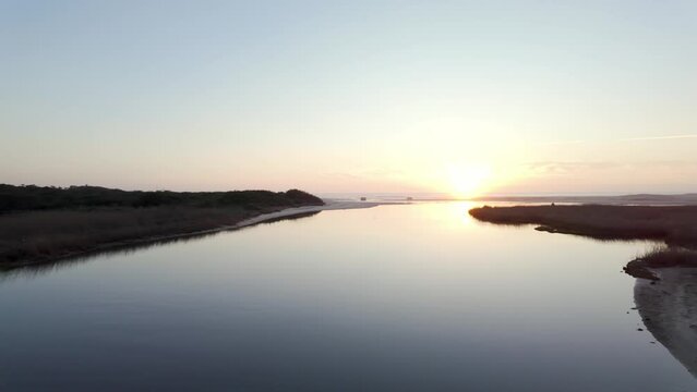 View from the wooden bridge over the water. Sunset light light in Esmoriz, Ovar - Portugal.
