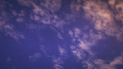 clouds and stars in the blue night sky