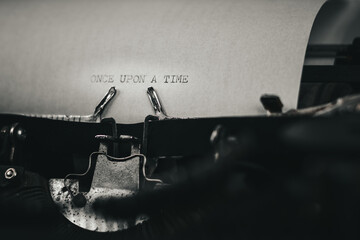ONCE UPON A TIME typed words on a vintage typewriter. Close up. Antique Typewriter.