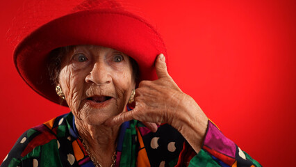 Funny happy elderly senior woman with no teeth pointing fingers herself say call me, smiling...