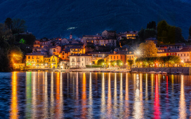 Fototapeta na wymiar The beautiful village of Mergozzo, illuminated in the evening. Piedmont region, northern Italy.