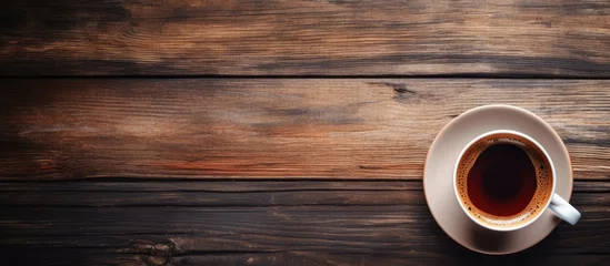 Foto op Plexiglas Inviting Cup of Freshly Brewed Coffee on Rustic Wooden Table in Cozy Cafe © Gular
