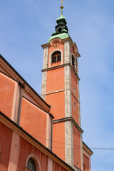 Fototapeta premium Franciscan Church of the Annunciation (Frančiškanska cerkev Marijinega oznanjenja) from the historic center street Miklošičeva Cesta towards Prešernov Trg square, Ljubljana, Slovenia