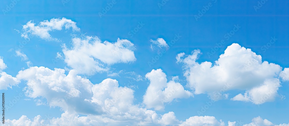 Aufkleber tranquil coastal scene with fluffy clouds over pristine beach on a sunny day
