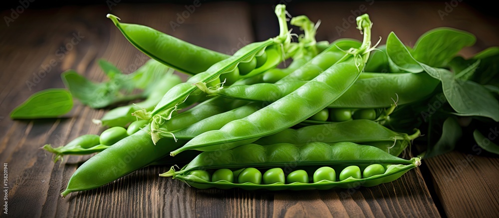 Poster fresh organic green peas arranged in a rustic setting on a wooden table