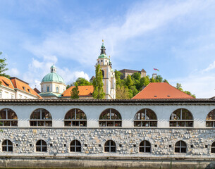 Mesarski most, butcher's bridge, bridge with padlocks spans the promenade Ljubljanica River, with viewa to Ljubljana Central Market and Saint Nicholas's Cathedral and Ljubljana Castle, Slovenia