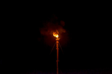 torch with fire from an oil refinery
