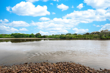 Neiva, Huila, Colombia. May 2019: Panoramic landscape with blue boat on the bank of the Magdalena...