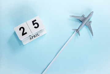 April calendar with number  25. Top view of a calendar with a flying passenger plane. Scheduler....