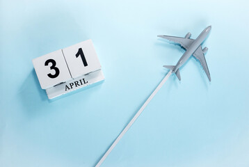 April calendar with number  31. Top view of a calendar with a flying passenger plane. Scheduler....