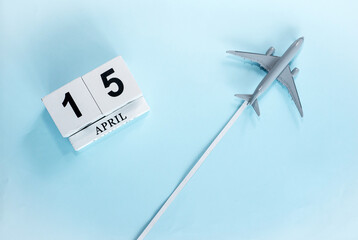 April calendar with number  15. Top view of a calendar with a flying passenger plane. Scheduler....
