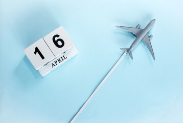 April calendar with number  16. Top view of a calendar with a flying passenger plane. Scheduler....
