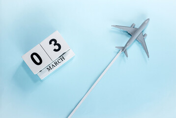 March calendar with number  3. Top view of a calendar with a flying passenger plane. Scheduler....