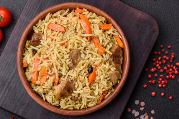 Delicious pilaf with vegetables, salt, spices and herbs in a ceramic plate
